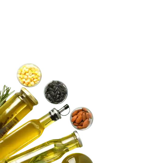 Glass bottles of cooking oil with small bowls of corn kernels, sunflower seeds, and almonds on a clean gray background.