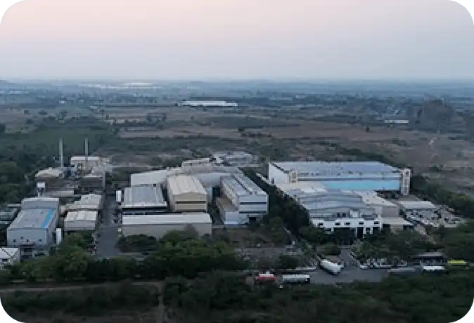 Panoramic aerial view of Synthite’s industrial plant surrounded by fields, showcasing large-scale production and environmental harmony.