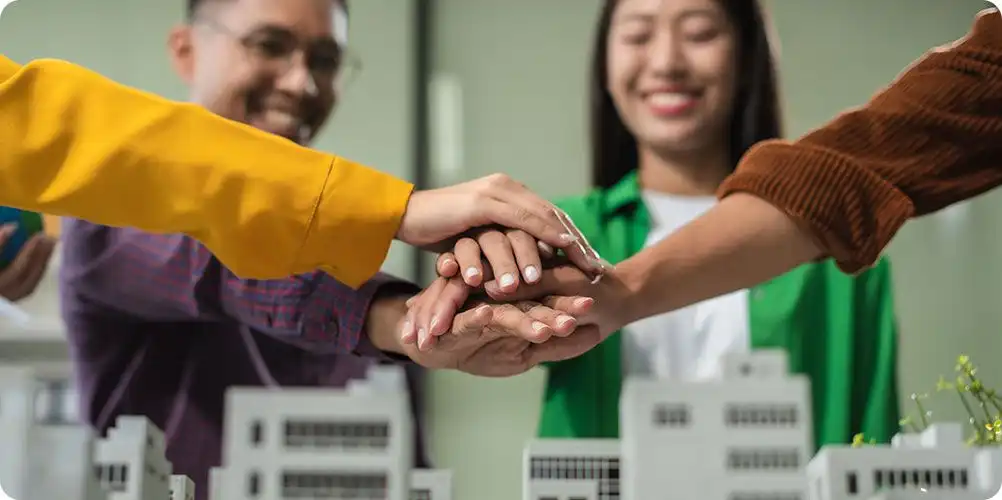 Hand gathering items or forming a loose cluster, representing community, cooperation, or collective effort.