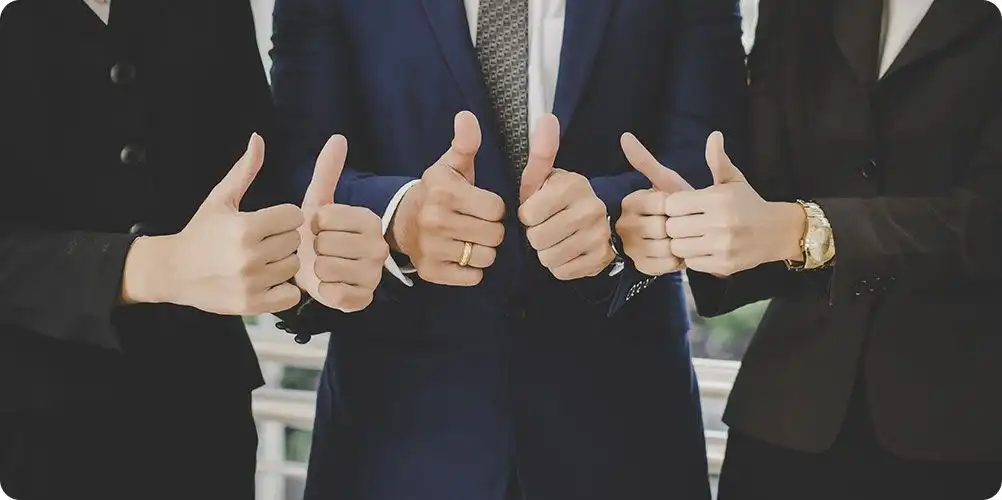 Collage of employee testimonials with portraits of diverse team members showing thumpsup alongside quotes highlighting positive work culture, personal growth, and job satisfaction.