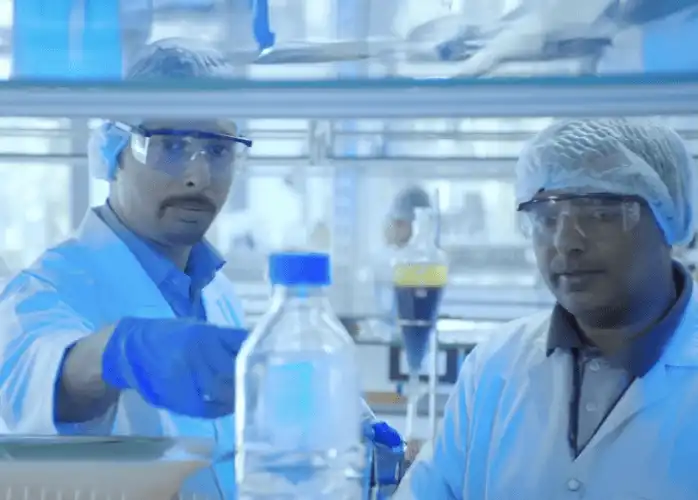 Scientists in a Synthite laboratory conducting natural extract research with advanced equipment, showcasing innovation and quality control.