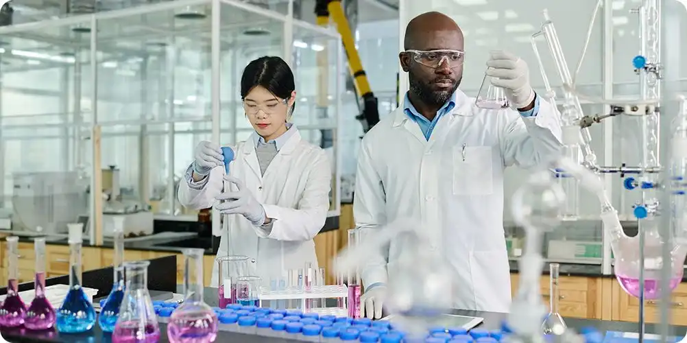 Technology breakthroughs banner with close-up of a researcher holding a test tube and lab equipment in the background, representing scientific advancements.