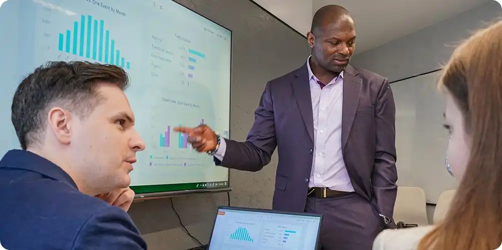 ROI demonstrations image featuring a rising graph overlaid on a business meeting background, representing financial performance.