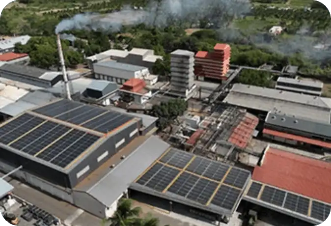 Exterior view of a glass modern corporate office building under blue sky.