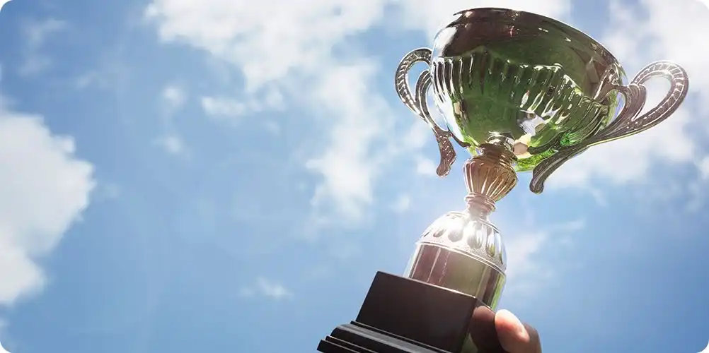 Industry recognition image featuring a business leader receiving an award or honor, highlighting external validation.