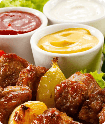 Ketchup sauce in bottle and bowl, condiment product.