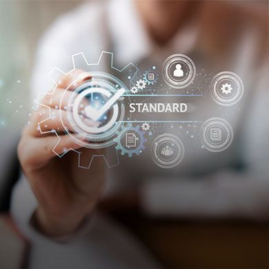 Graphic representing compliance standards, showing a checked badge icon, the word STANDARD, and digital gear symbols.