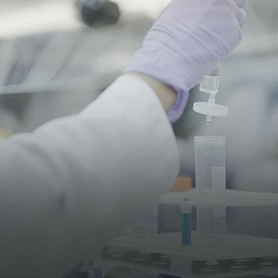 Mobile version of research collaboration banner featuring professionals collaborating at a workspace with laptops and papers, optimized for smaller screens.